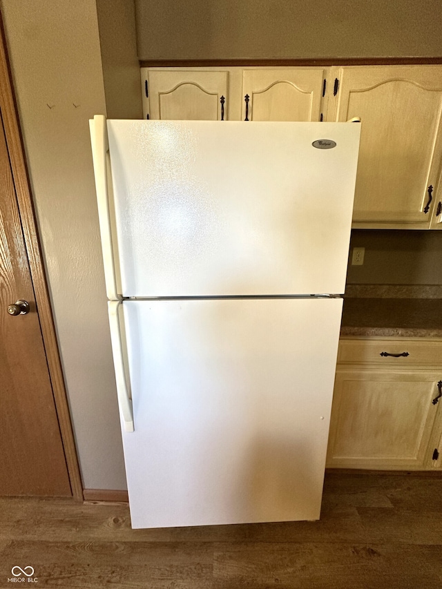 interior details featuring white fridge and dark hardwood / wood-style flooring