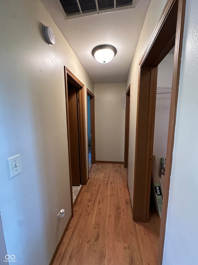 corridor with light hardwood / wood-style flooring