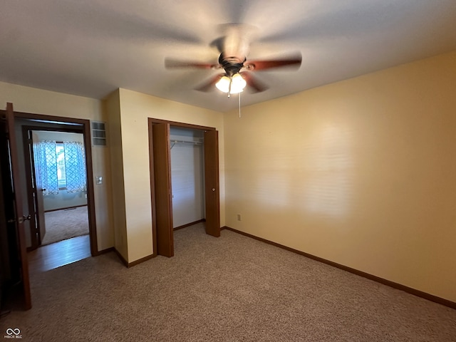 unfurnished bedroom featuring dark carpet, ceiling fan, and a closet