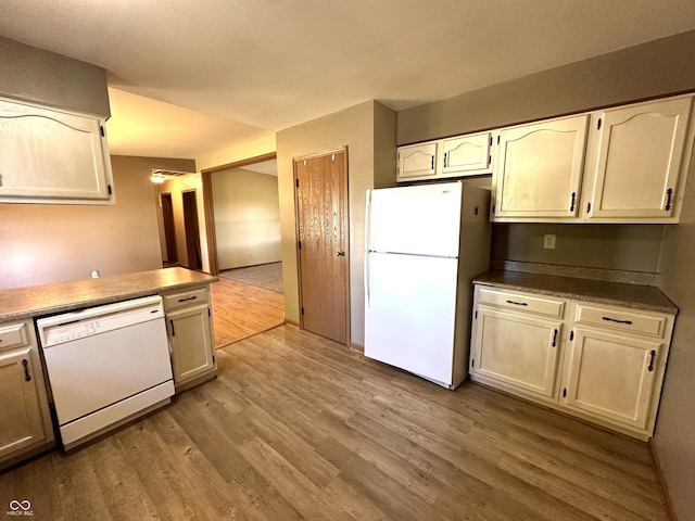 kitchen featuring light hardwood / wood-style floors and white appliances