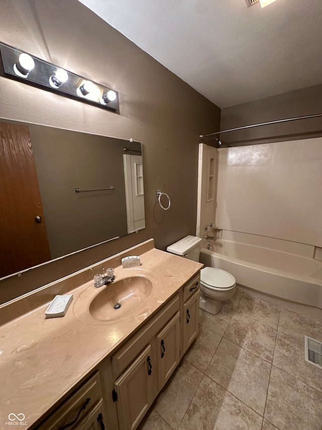 full bathroom with tile patterned floors, washtub / shower combination, vanity, and toilet