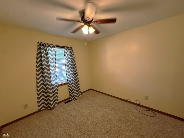 empty room with ceiling fan and carpet flooring