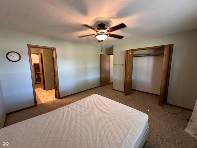 unfurnished bedroom featuring light carpet, a closet, ceiling fan, and a textured ceiling