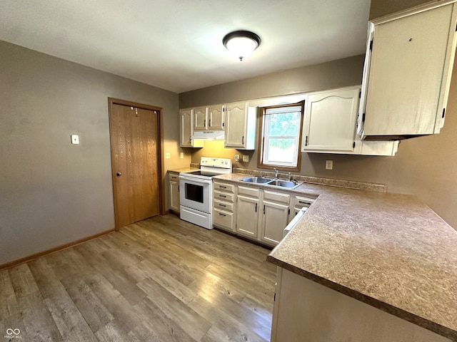 kitchen featuring light wood-type flooring, electric stove, and sink