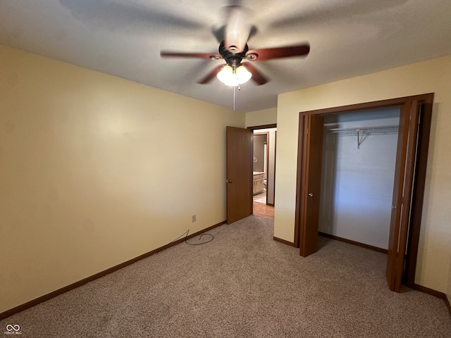 unfurnished bedroom with ceiling fan, a closet, and light carpet