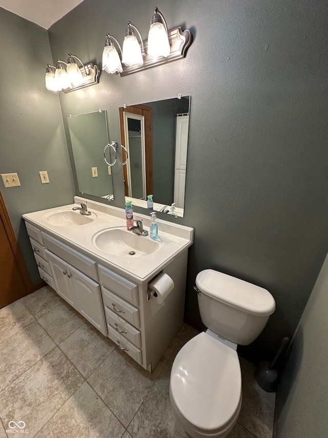 bathroom featuring vanity, toilet, and tile patterned floors