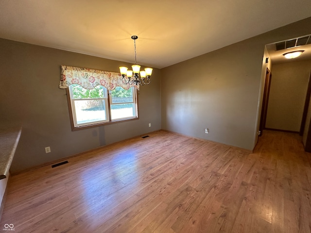 interior space with a notable chandelier and hardwood / wood-style flooring