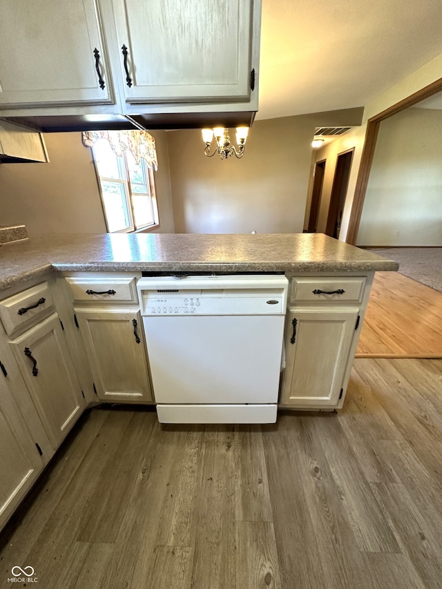 kitchen featuring wood-type flooring, white dishwasher, and kitchen peninsula