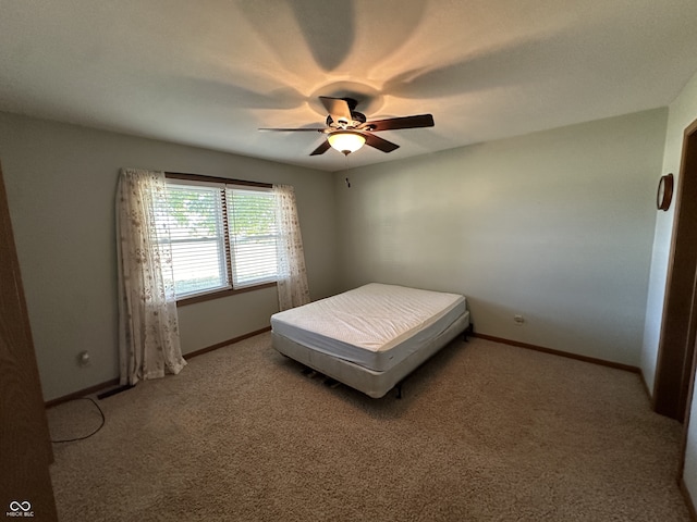 unfurnished bedroom featuring ceiling fan and carpet