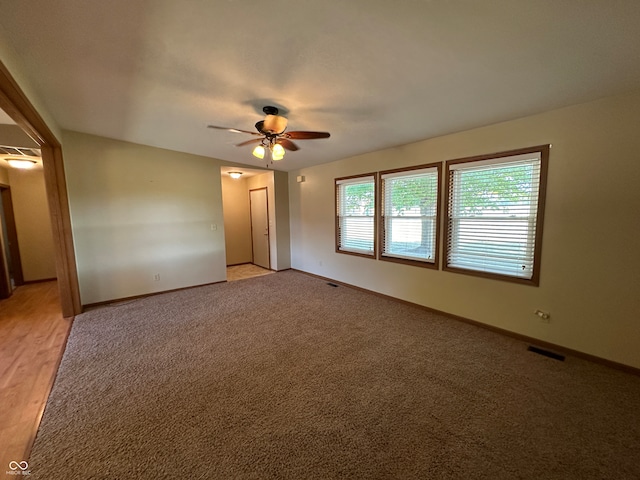 spare room featuring light hardwood / wood-style floors and ceiling fan