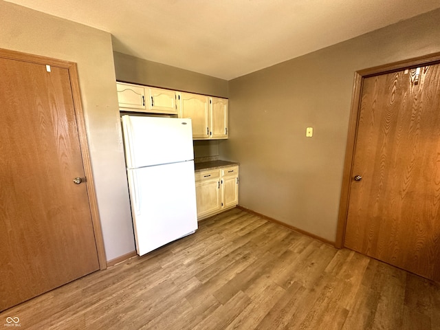 kitchen with light hardwood / wood-style flooring and white refrigerator