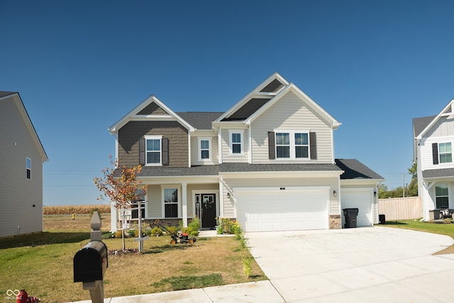 view of front of property featuring a front yard and a garage