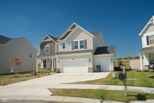 craftsman inspired home with a garage and a front yard