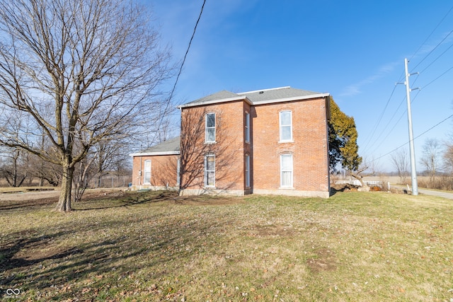 rear view of house featuring a yard