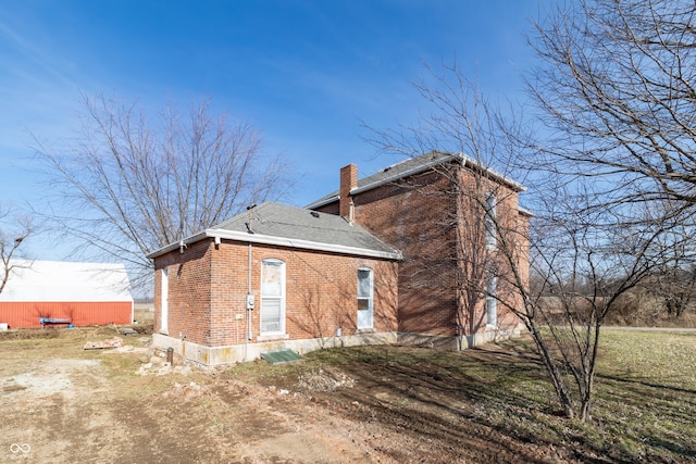 9517 N 550 W, Carthage, IN 46115 - view of side of property with brick siding, a shingled roof, and a chimney