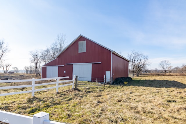 view of outdoor structure with a rural view and a yard