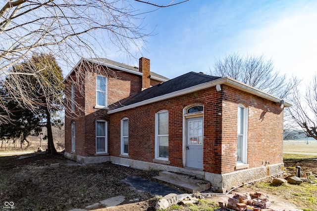 9517 N 550 W, Carthage, IN 46115 - view of front of home featuring entry steps, brick siding, a chimney, and a shingled roof