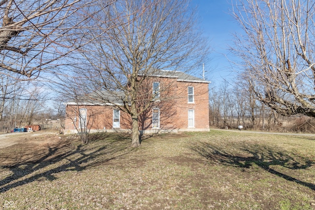 view of side of home with a lawn