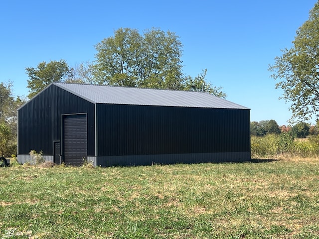 view of outbuilding with a yard