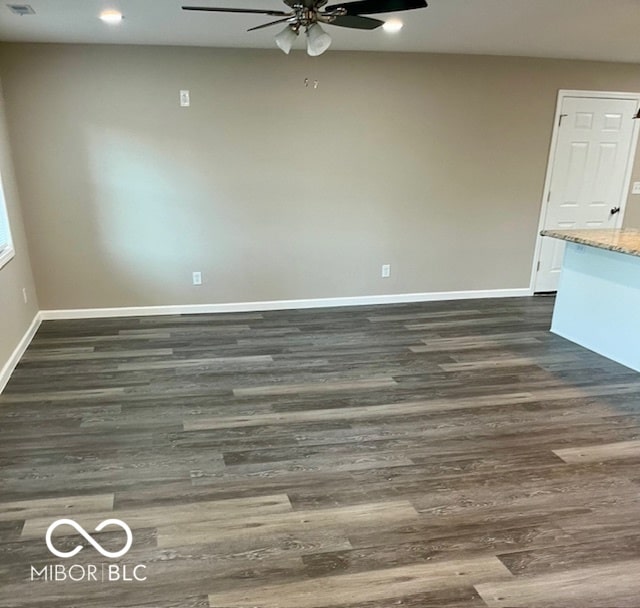 unfurnished room with dark wood-type flooring and ceiling fan