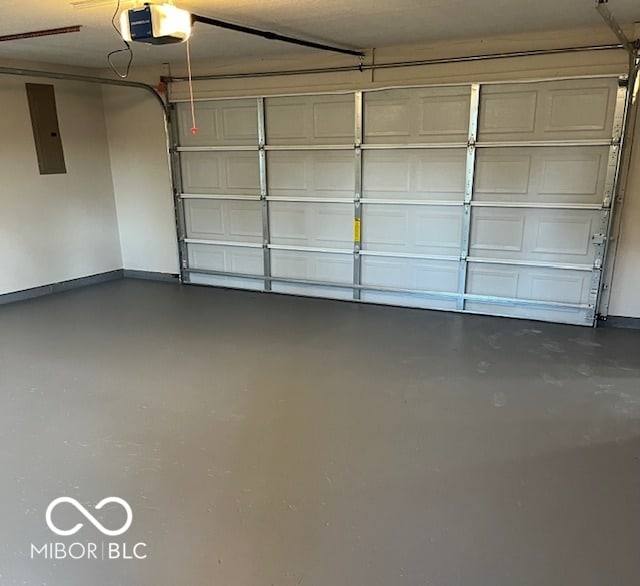 garage featuring electric panel and a garage door opener