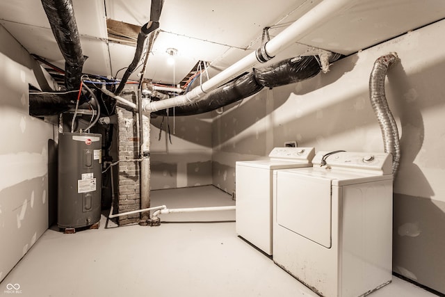 clothes washing area featuring separate washer and dryer and electric water heater