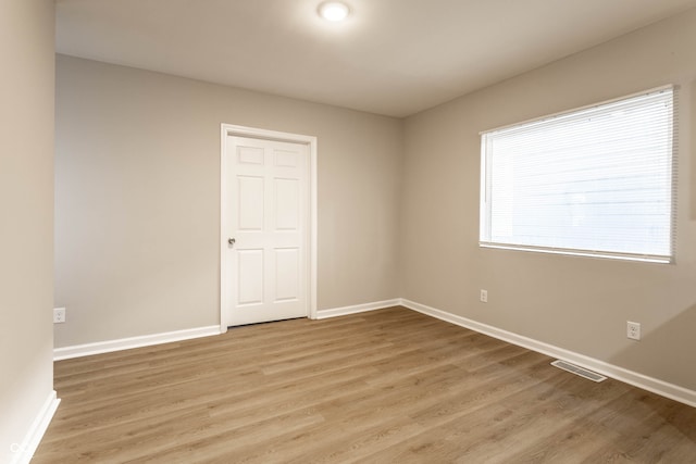 spare room with light wood-type flooring