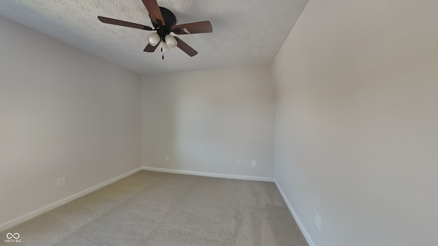 empty room featuring ceiling fan, carpet floors, and a textured ceiling