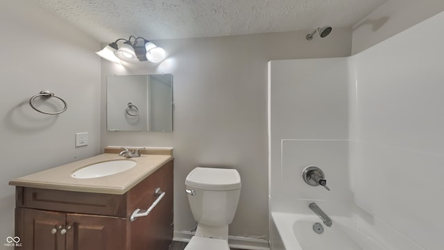 full bathroom featuring a textured ceiling, bathing tub / shower combination, vanity, and toilet