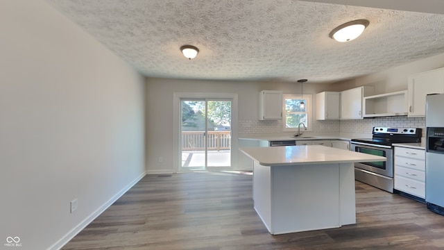 kitchen featuring white cabinetry, electric stove, a kitchen island, hardwood / wood-style floors, and decorative light fixtures