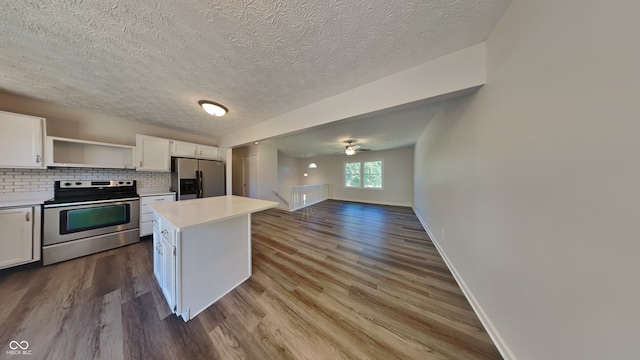 kitchen featuring wood-type flooring, a center island, white cabinetry, stainless steel appliances, and backsplash