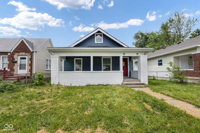 view of front facade featuring a front lawn and covered porch