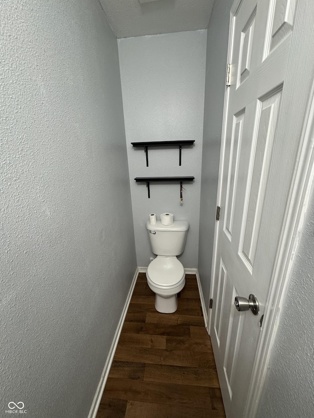 2307 Blackthorn Dr, Franklin, IN 46131 - bathroom featuring wood finished floors, baseboards, toilet, and a textured wall