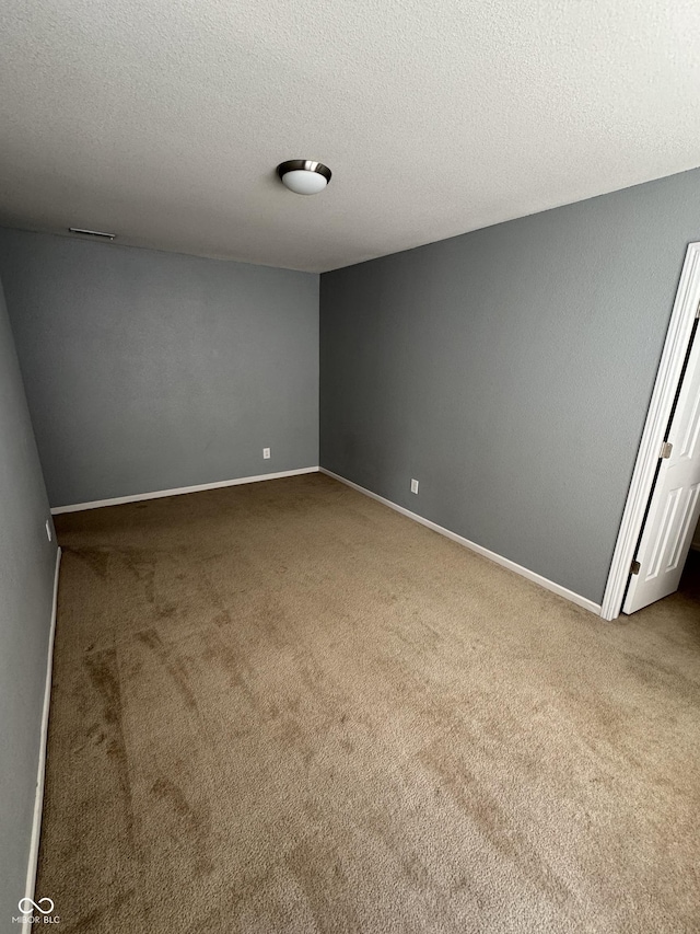 2307 Blackthorn Dr, Franklin, IN 46131 - empty room with carpet flooring, a textured ceiling, and baseboards
