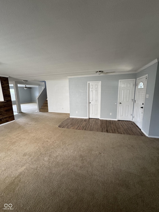 2307 Blackthorn Dr, Franklin, IN 46131 - unfurnished living room featuring dark colored carpet, ceiling fan, a textured ceiling, crown molding, and baseboards