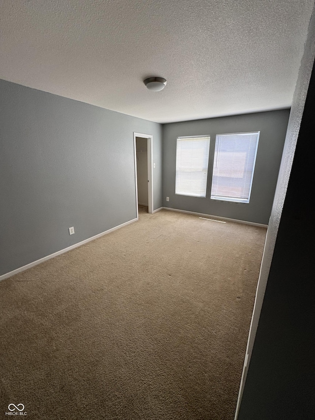 2307 Blackthorn Dr, Franklin, IN 46131 - spare room featuring light carpet, a textured ceiling, and baseboards