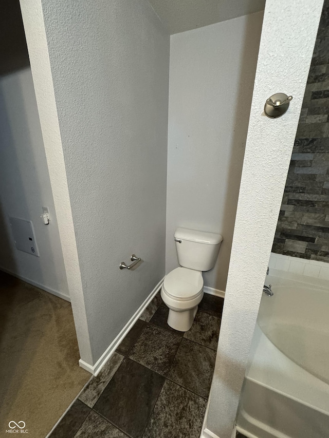 2307 Blackthorn Dr, Franklin, IN 46131 - bathroom with toilet, a bath, and baseboards