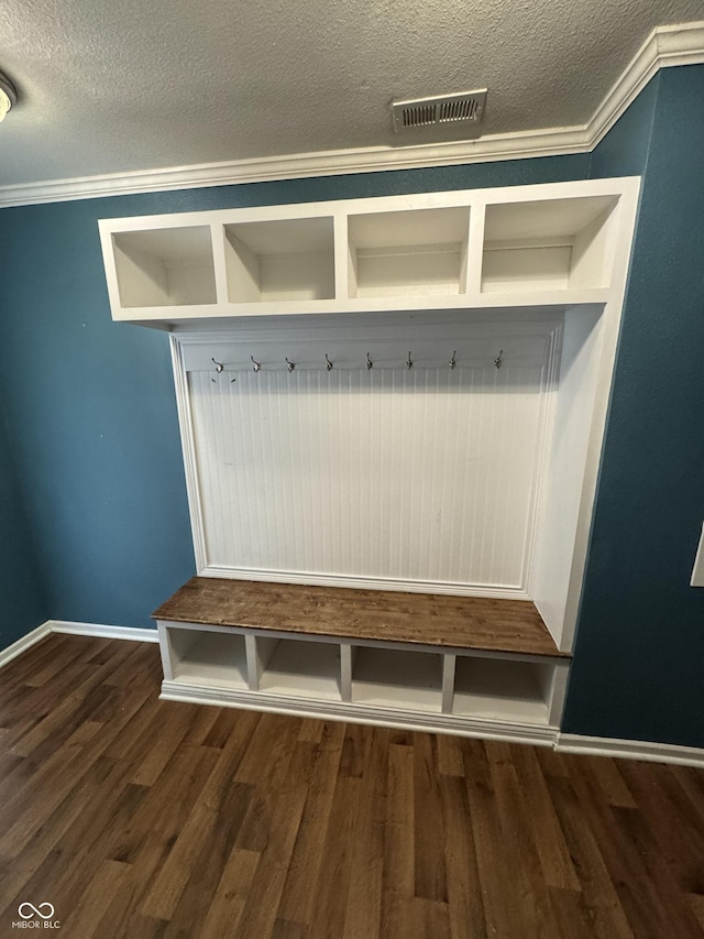 2307 Blackthorn Dr, Franklin, IN 46131 - mudroom featuring dark wood-style flooring, a textured ceiling, crown molding, and baseboards