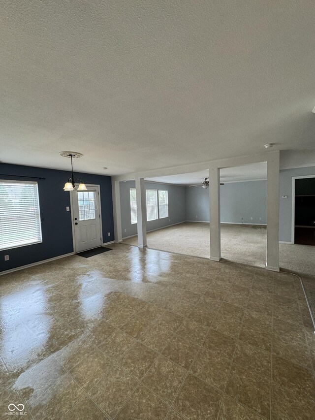 2307 Blackthorn Dr, Franklin, IN 46131 - unfurnished living room with a textured ceiling and baseboards