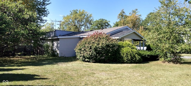 view of side of property featuring a yard