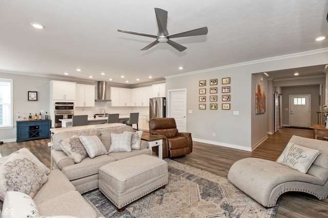 living room with ceiling fan, ornamental molding, sink, and dark hardwood / wood-style flooring