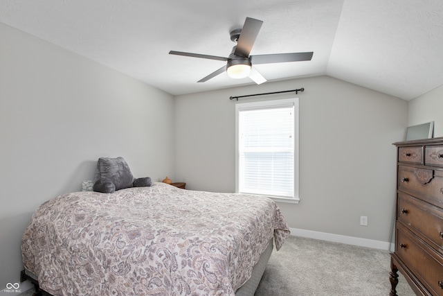 bedroom featuring ceiling fan, light colored carpet, and vaulted ceiling