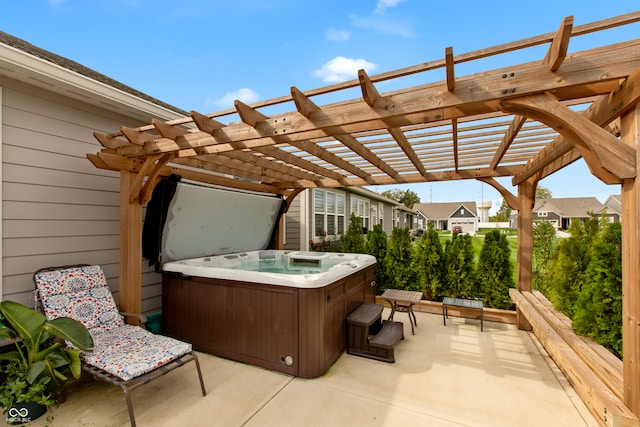 view of patio / terrace with a hot tub and a pergola