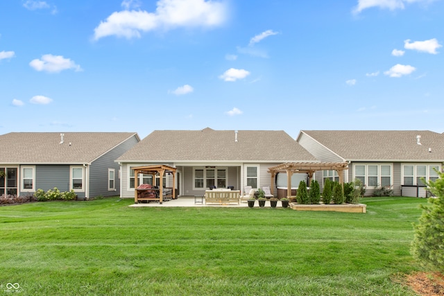 rear view of house with a pergola, a patio area, and a lawn