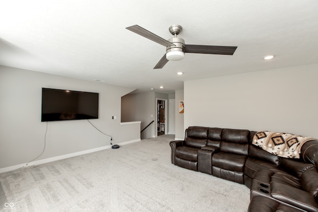 living room with carpet floors, a textured ceiling, and ceiling fan