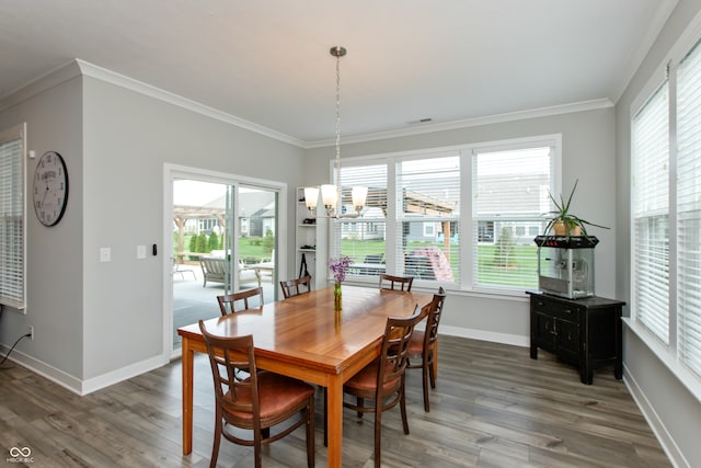 dining room featuring crown molding, dark hardwood / wood-style flooring, and plenty of natural light