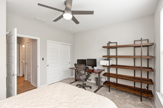 carpeted bedroom with a closet and ceiling fan