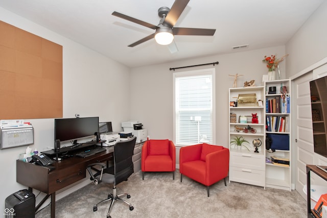 office space featuring ceiling fan and light colored carpet