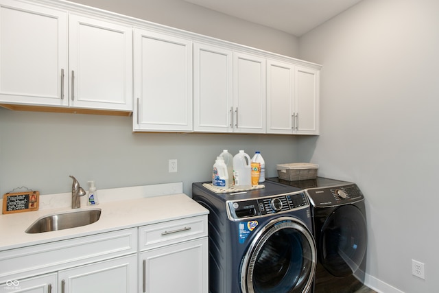 washroom with separate washer and dryer, sink, and cabinets