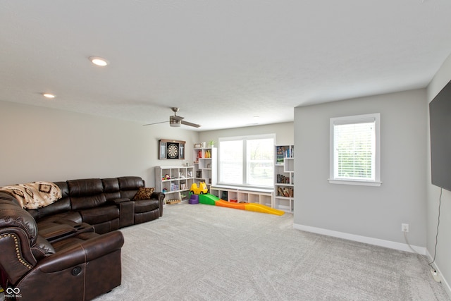 carpeted living room featuring ceiling fan